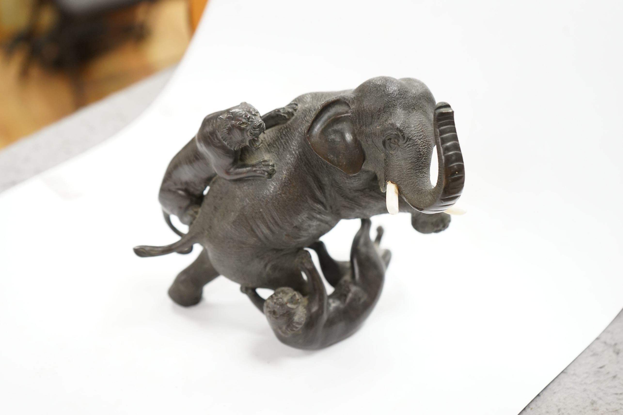 After Genryusai Seiya (1868-1912), a 19th century Japanese Meiji period cast bronze group of an elephant being attacked by tigers, seal mark, 14cm high. CITES Submission reference P5SHZWF1. Condition - good